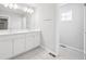 Elegant bathroom with double sinks, granite countertops, and a separate toilet area at 7376 Watercress Dr, Littleton, CO 80125