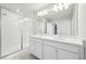 Modern bathroom featuring a glass-enclosed shower and double sink vanity at 7376 Watercress Dr, Littleton, CO 80125