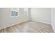Bedroom with wood-look floors and two windows at 7376 Watercress Dr, Littleton, CO 80125