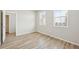 Bedroom with wood-look floors and two windows at 7376 Watercress Dr, Littleton, CO 80125