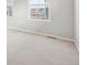 Bright bedroom featuring two windows and neutral carpet for comfort at 7376 Watercress Dr, Littleton, CO 80125