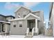Charming two-story home with gray siding, white trim, and inviting front porch at 7376 Watercress Dr, Littleton, CO 80125