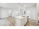 Well-lit kitchen features a large island, stainless steel appliances, and modern lighting at 7376 Watercress Dr, Littleton, CO 80125