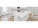 Modern kitchen with white island, cabinetry, and stainless steel appliances at 7376 Watercress Dr, Littleton, CO 80125
