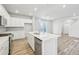 Modern kitchen features white cabinets, stainless steel appliances, and a spacious island with sink at 7376 Watercress Dr, Littleton, CO 80125