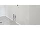 Functional laundry area with tile flooring and utility connections at 7376 Watercress Dr, Littleton, CO 80125