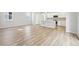 Open-concept living space featuring light hardwood flooring flowing into the kitchen at 7376 Watercress Dr, Littleton, CO 80125