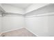 Spacious walk-in closet with shelving and carpet flooring for storage at 7376 Watercress Dr, Littleton, CO 80125