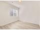 Bright, airy bedroom with light wood floors and a large window at 374 N Geneva St, Aurora, CO 80010