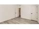 Clean bedroom with minimalist design, light wood floors, and neutral walls at 374 N Geneva St, Aurora, CO 80010