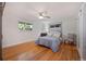 Bright bedroom with hardwood floors, a ceiling fan, and ample natural light from the large windows at 703 S Oneida Way, Denver, CO 80224