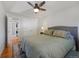 Comfortable bedroom featuring a ceiling fan, a neutral color scheme, and convenient access to the laundry closet at 703 S Oneida Way, Denver, CO 80224