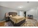 Spacious bedroom with a ceiling light, a soft rug, and access to a walk-in closet and ensuite at 703 S Oneida Way, Denver, CO 80224