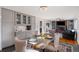 Inviting dining area featuring a stylish chandelier and convenient built-in wet bar and cabinets at 703 S Oneida Way, Denver, CO 80224