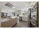 Modern kitchen with stainless steel appliances, white cabinets, an island, and sleek countertops at 703 S Oneida Way, Denver, CO 80224