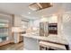 Modern kitchen featuring white cabinets, stainless steel appliances, and a marble countertop island at 703 S Oneida Way, Denver, CO 80224