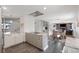 Open kitchen with modern appliances, gray cabinets, island, and seamless flow to the living and dining area at 703 S Oneida Way, Denver, CO 80224