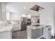 Bright kitchen with white subway tile backsplash, stainless steel appliances, and marble countertops at 703 S Oneida Way, Denver, CO 80224
