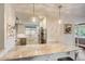 Bright kitchen with marble countertops, stainless steel appliances, and stylish pendant lighting at 703 S Oneida Way, Denver, CO 80224