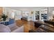 Open-concept living area with hardwood floors, comfortable seating, and stylish decor at 703 S Oneida Way, Denver, CO 80224