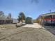 Spacious backyard featuring a shed and a covered patio area, perfect for outdoor activities at 7870 Kimberly St, Commerce City, CO 80022