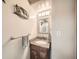 Well-lit bathroom vanity with granite countertop and decorative mirror at 7870 Kimberly St, Commerce City, CO 80022