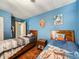 bedroom features twin beds and wood flooring at 7870 Kimberly St, Commerce City, CO 80022
