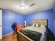 Bedroom featuring bright blue walls with natural light and hardwood flooring, creating a calm space at 7870 Kimberly St, Commerce City, CO 80022