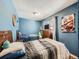 Blue bedroom with hardwood floors and twin beds at 7870 Kimberly St, Commerce City, CO 80022