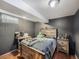 Bedroom with gray walls, hardwood floors, and wooden furniture at 7870 Kimberly St, Commerce City, CO 80022