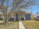 Inviting front exterior with mature trees and a cozy bench at 7870 Kimberly St, Commerce City, CO 80022
