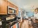 Open kitchen area with stainless steel appliances and barstool seating at 7870 Kimberly St, Commerce City, CO 80022