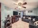 Finished basement living area featuring tile flooring, ceiling fan, and fireplace at 7870 Kimberly St, Commerce City, CO 80022
