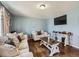 Comfortable living area featuring hardwood floors and a large television at 7870 Kimberly St, Commerce City, CO 80022