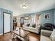 Cozy living room with hardwood floors and a view to the front entry at 7870 Kimberly St, Commerce City, CO 80022