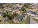 Spacious landscaped backyard surrounded by mature trees, with the home featuring brick exterior at 6023 E 6Th Avenue Pkwy, Denver, CO 80220