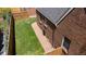 Aerial shot of the backyard of a brick home featuring a well-kept lawn and paved pathway for outdoor enjoyment at 6023 E 6Th Avenue Pkwy, Denver, CO 80220