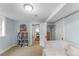 Comfortable bedroom with neutral paint, an adjacent bookshelf and an open door offering a glimpse of other rooms at 6023 E 6Th Avenue Pkwy, Denver, CO 80220