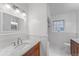 Well-lit bathroom with marble countertops, white subway tile, and classic fixtures at 6023 E 6Th Avenue Pkwy, Denver, CO 80220