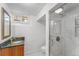 Modern bathroom with a glass shower, marble tiling, and a stylish vanity with a granite countertop and updated fixtures at 6023 E 6Th Avenue Pkwy, Denver, CO 80220