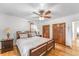 Bedroom showcasing hardwood floors, a ceiling fan, and warm natural light coming from the windows at 6023 E 6Th Avenue Pkwy, Denver, CO 80220