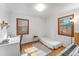 Bright bedroom offering hardwood floors, two windows, and ample space for a twin bed and a desk at 6023 E 6Th Avenue Pkwy, Denver, CO 80220