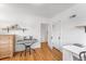 Well-lit bedroom features hardwood floors, a desk, and a dresser, offering a functional space at 6023 E 6Th Avenue Pkwy, Denver, CO 80220