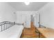 Hardwood bedroom with a bed, a window, and a table with a chair, providing a cozy retreat at 6023 E 6Th Avenue Pkwy, Denver, CO 80220