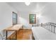 Bedroom featuring hardwood floors, two windows, and offering space for a twin bed and long desk at 6023 E 6Th Avenue Pkwy, Denver, CO 80220
