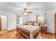 Comfortable bedroom with a ceiling fan, wood trim windows, and beautiful hardwood floors at 6023 E 6Th Avenue Pkwy, Denver, CO 80220