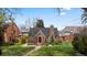 Quaint brick home with a well-manicured lawn and inviting entryway showcasing classic charm and curb appeal at 6023 E 6Th Avenue Pkwy, Denver, CO 80220