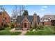 Charming brick home with a red front door, chimney, and well-maintained landscaping at 6023 E 6Th Avenue Pkwy, Denver, CO 80220
