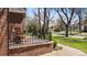 Inviting front porch featuring brick detail and seating area with wrought iron railing at 6023 E 6Th Avenue Pkwy, Denver, CO 80220