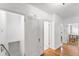 Bright hallway features hardwood floors, white walls, and doorways to other rooms for easy home navigation at 6023 E 6Th Avenue Pkwy, Denver, CO 80220